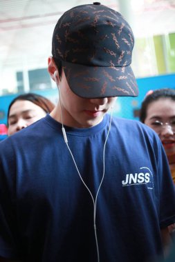 South Korean singer and actor Oh Se-hun, better known mononymously as Sehun, of South Korean boy group EXO arrives at the Beijing Capital International Airport in Beijing, China, 20 July 2018. clipart