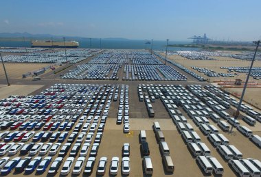 Vehicles to be shipped to abroad are lined up on the quay of a port in Dalian city, northeast China's Liaoning province, 12 August 2018 clipart