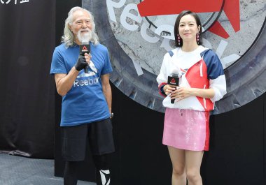Chinese singer and actress Victoria Song or Song Qian, right, and 82-year-old Chinese model Wang Deshun attend a promotional event for 