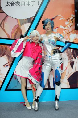 Showgirls dressed in cosplay costumes pose during the 14th China International Cartoon & Game Expo (CCG Expo 2018) in Shanghai, China, 5 July 2018 clipart