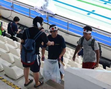 Japanese fans clean the natatorium's stand after a swimming match in the 2018 Asian Games, officially known as the 18th Asian Games and also known as Jakarta Palembang 2018, in Jakarta, Indonesia, 20 August 2018 clipart