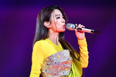 Hebe Tien Fu-chen of Taiwanese girl group S.H.E performs during the 2019 Hunan TV New Year Concert in Guangzhou city, south China's Guangdong province, 31 December 2018. clipart