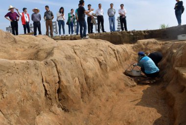 Chinese workers investigate the excavation site of the Shimen Pagoda ruins to unearth relics, which are mainly from the Shang Dynasty (c.1600 BC-1046 BC), along the Lishui River in Chujiang town, Shimen county, Changde city, central China's Hunan pro clipart