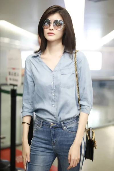 File--In this undated photo, Chinese model He Sui arrives at a Shanghai  airport befoere departure in Shanghai, China. Shoulder bag: Louis Vuitton  (Photo by Wang Jiali/ChinaImages/Sipa USA Stock Photo - Alamy