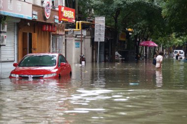 A car is half submerged on a flooded road caused by heavy rainstorm in Tianjin, China, 24 July 2018 clipart