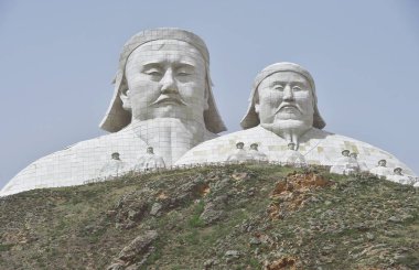The 50-meter-tall giant stutue in the shape of Genghis Khan and the lower giant statue with a height of 30 meters in the shape of Kublai Khan are on display at a scenic spot in Xilingol League, north China's Inner Mongolia Autonomous Region, 3 June 2 clipart