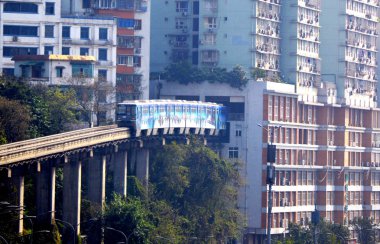 The No.2 light-rail train drives through a building in Liziba Station, Chongqing Municipality clipart