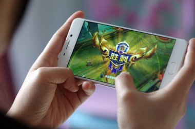 A Chinese mobile game player plays Tencent's mobile MOBA 