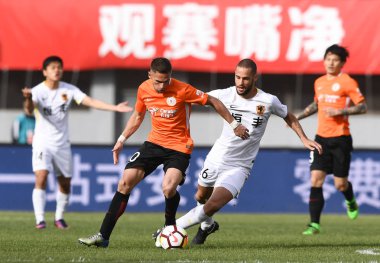 Spanish soccer player Mario Suarez of Guizhou Hengfeng, right, challenges Brazilian football player Ivo of Beijing Renhe in their sixth round match during the 2018 Chinese Football Association Super League (CSL) in Beijing, China, 14 April 2018