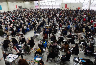 Over 6,000 Chinese students take part in the National College Entrance Examination for art majors at the Ji'nan Shungeng International Convention and Exhibition Center in Ji'nan city, east China's Shandong province, 24 February 2018. clipart