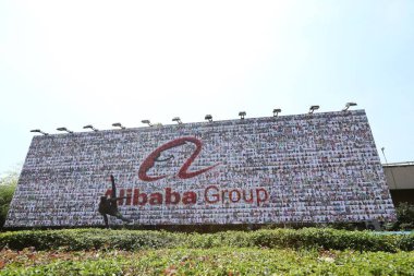 View of a logo of Alibaba Group before the annual party to mark the 18th anniversary of the founding of Chinese e-commerce giant Alibaba Group at the Yellow Dragon Sports Center in Hangzhou city, east China's Zhejiang province, 8 September 20 clipart