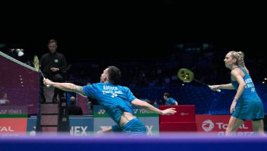 Chris Adcock, left, and his wife Gabrielle Adcock of England compete against Yuta Watanabe and Arisa Higashino of Japan in their quarterfinal match of the mixed doubles during the YONEX All England Open Badminton Championships 2018 in Birmingham, UK, clipart