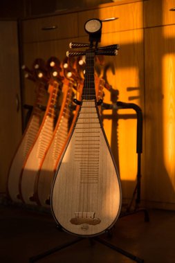 Pipa, a four-stringed Chinese musical instrument, made by Chinese craftsman Li Zhaolin is displayed at his studio in Suzhou city, east China's Jiangsu province, 14 March 2018 clipart
