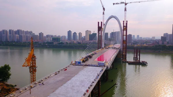 Aerial view of the construction site of the Baisha bridge, the world's largest asymmetrical cable-stayed bridge, to open soon in Liuzhou city, south China's Guangxi Zhuang Autonomous Region, 20 June 2018 — Stock Image Aerial View Construction Site Baisha Bridge World Largest Asymmetrical Cable Royalty Free Stock Images