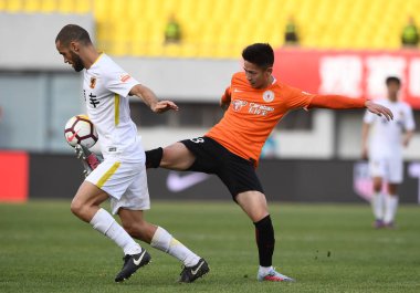 Spanish soccer player Mario Suarez of Guizhou Hengfeng, left, challenges Wang Chu of Beijing Renhe in their sixth round match during the 2018 Chinese Football Association Super League (CSL) in Beijing, China, 14 April 2018