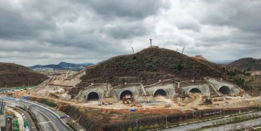 Chinese construction workers dig tunnels in a hill for Tencent to build a data center in Guiyang city, southwest China's Guizhou province, 7 March 2018 clipart