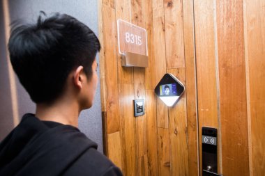 A Chinese man without his ID card on him enters the hotel room he booked by face recognition after using the 