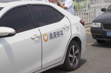 A logo of Chinese taxi-hailing and car-service app Didi Chuxing is seen on a car in Anshan city, northeast China's Liaoning province, 24 June 2018 clipart