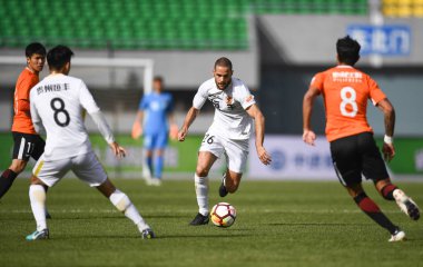 Spanish soccer player Mario Suarez of Guizhou Hengfeng, center, dribbles the ball against Beijing Renhe in their sixth round match during the 2018 Chinese Football Association Super League (CSL) in Beijing, China, 14 April 2018