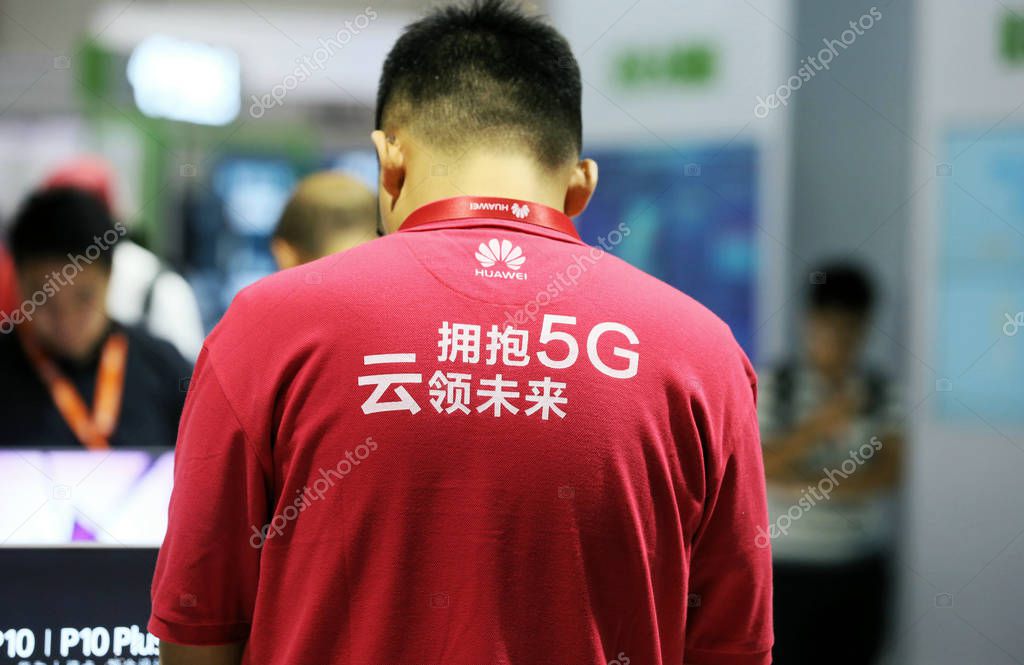 --FILE--An employee dressed in a uniform with a logo of 5G at the stand of Huawei during the PT/EXPO CHINA 2017 in Beijing, China, 30 September 2017