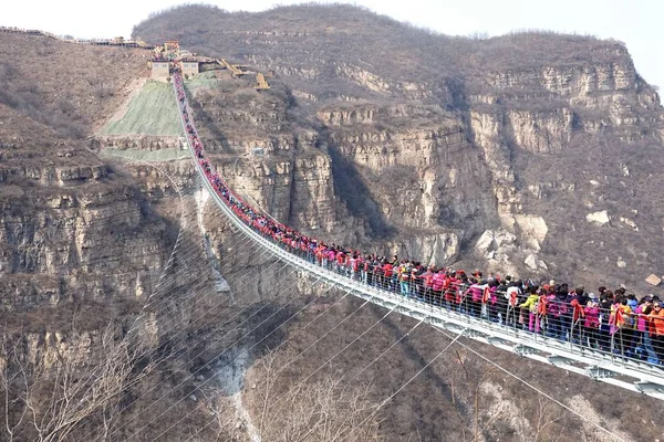 stock image Tourists throng to walk on the world's longest glass bridge in the Hongyagu Scenic Area in Pingshan county, Shijiazhuang city, north China's Hebei province, 20 March 2018
