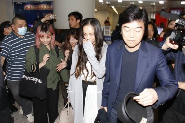 Japanese singer Namie Amuro heads for the exit after landing at the Hong Kong International Airport in Hong Kong, China, 28 March 2018. clipart