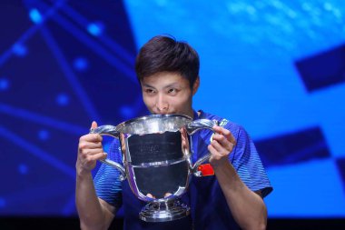 Shi Yuqi of China poses with his trophy after defeating Lin Dan of China in the final match of the men's singles during the YONEX All England Open Badminton Championships 2018 in Birmingham, UK, 18 March 2018 clipart