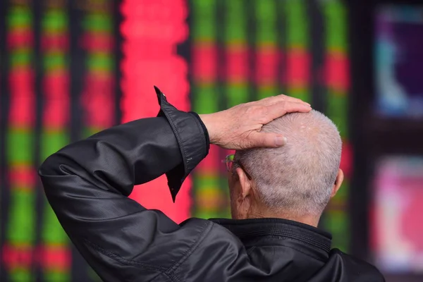 2018 日中国東部の安徽省阜陽市の証券会社の家で 赤の価格上昇 と価格下落のため緑の株式の価格を見て 中国の投資家が反応します — ストック写真