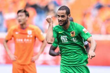 Spanish soccer player Mario Suarez of Guizhou Hengfeng celebrates after scoring against Shandong Luneng Taishan in their fourth round match during the 2018 Chinese Football Association Super League (CSL) in Ji'nan city, east China's Shandong province
