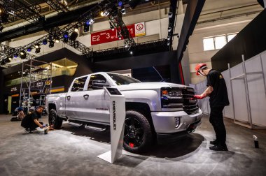 Chinese workers dust off a Chevrolet Silverado Z71 pickup of General Motors (GM) on display during a preview of the 15th Beijing International Automotive Exhibition, also known as Auto China 2018, in Beijing, China, 24 April 2018 clipart