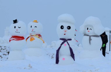 2018 sculptures of snowmen are on display at an ice and snow park in Harbin city, northeast China's Heilongjiang province, 8 January 2018 clipart