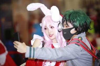 Chinese cosers dressed in cosplay costumes pose during the 25th I Do ACG Expo in Beijing, China, 31 December 2017 clipart