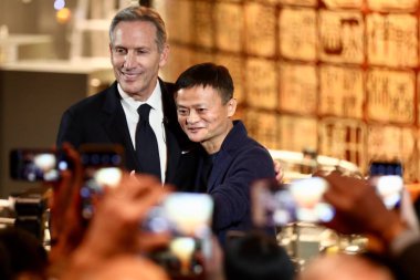 Howard Schultz, left, chairman of American coffee company and coffeehouse chain Starbucks, and Jack Ma or Ma Yun, chairman of Chinese e-commerce giant Alibaba Group, attend a press conference for the Starbucks Reserve Roastery in Shanghai, China, 5 D clipart
