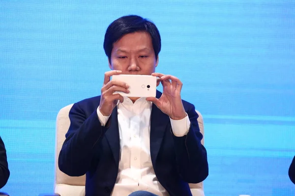 小米科技董事长 金山公司董事长雷军在第四届世界互联网大会上 用他的 Mix 智能手机为观众拍照 — 图库照片
