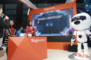 Sougou's 'Wangzai' robot is competing with humans in a quiz at the stand of Chinese Internet search engine Sogou during the fourth World Internet Conference (WIC), also known as Wuzhen Summit, in Wuzhen town, Tongxiang city, Jiaxing city, east China' clipart