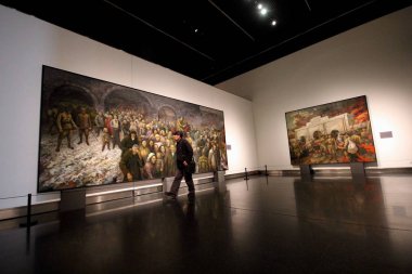 Oil paintings in commemoration of the Nanjing Massacre are on display at Jiangsu Art Museum in Nanjing city, east China's Jiangsu province, 12 December 2017 clipart