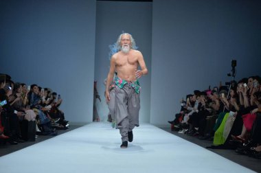 79-year-old Chinese actor Wang Deshun displays a new creation by Chinese fashion designer Sheguang Hu at the Sheguang Hu fashion show during the China Fashion Week Fall/Winter 2015 in Beijing, China, 25 March 2015 clipart