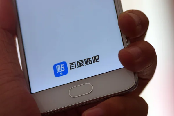 中国の携帯電話ユーザーは 検索エンジン会社Baiduの中国の通信プラットフォームBaidu Tiebaのモバイルアプリを 中国東部の山東省江南市でスマートフォンで使用しています 2017年9月11日 — ストック写真
