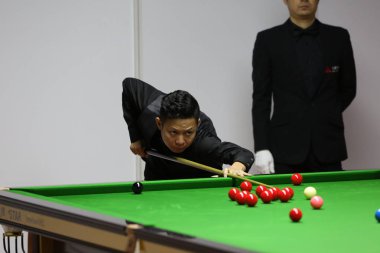 Mei Xiwen of China plays a shot to Kurt Maflin of Norway in their third round match during the 2017 Shanghai Masters snooker tournament in Shanghai, China, 16 November 2017 clipart