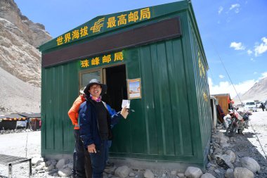 Travelers send postcards at the world's highest post office from Post China at Base camp on the Mount Everest in Shigatse, southwest China's Tibet Autonomous Region, 15 June 2017 clipart