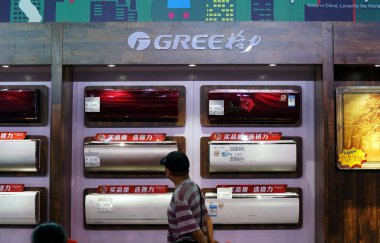 Chinese customer walks past air-conditioners of Chinese electronics maker Gree at a store in Tianjin, China, 27 August 2017 clipart