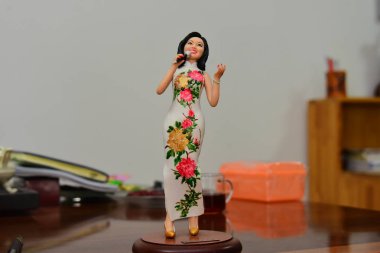 A clay figure of Taiwanese singer Teresa Teng made by Chinese craftsman Jia Guanghui is pictured at his studio in Zhengzhou city, central China's Henan province, 5 April 2017 clipart