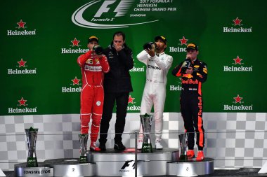 German F1 Sebastian Vettel of Ferrari, left, British F1 driver Lewis Hamilton of Mercedes, second right, and Dutch F1 driver Max Verstappen of Red Bull Racing, right, drink champagne during the award presentation ceremony of the 2017 Formula One Chin clipart
