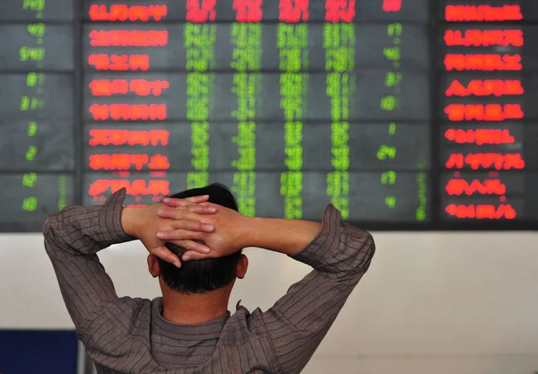 Concerned Chinese Investor Looks Prices Shares Red Price Rising Green — Stock Photo, Image