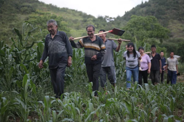 81-year-old Chinese man Huang Dafa leads villagers to chisel about 10 kilometers of irrigation channels into the vertical sides of three karst mountains in Caowangba village, Zunyi city, southwest China\'s Guizhou province, 20 June 2016