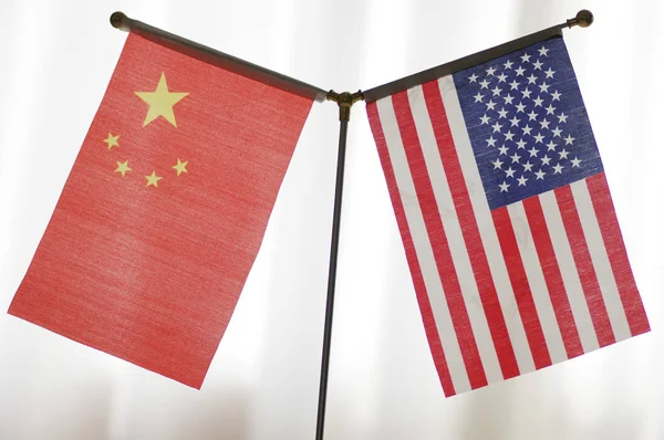 National flags of China and the United States are seen in Ji'nan city, east China's Shandong province, 14 June 2018.