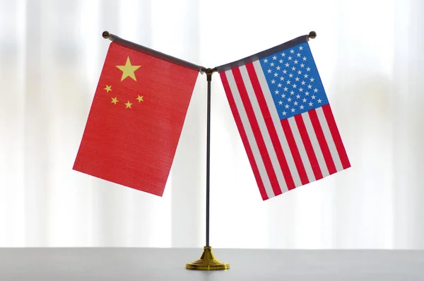 National flags of China and the United States are seen in Ji'nan city, east China's Shandong province, 14 June 2018.