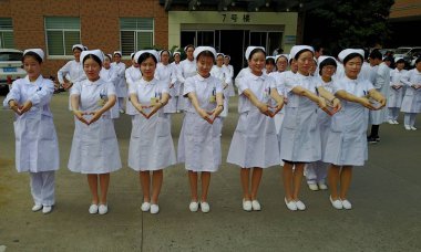 Nurses stand to form the numbers ''5.12'' during an event to mark International Nurses Day at a hospital in Yangzhou city, east China's Jiangsu province, 11 May 2017. clipart