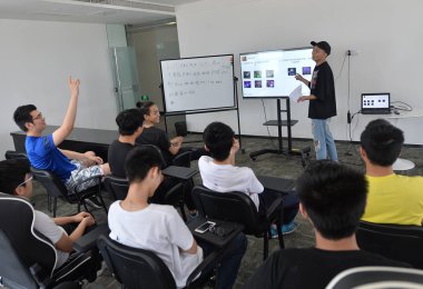 Chinese players take part in a closed E-sports training session at an office building in Chengdu city, southwest China's Sichuan province, 6 June 2017 clipart
