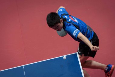 Tomokazu Harimoto of Japan serves against Florent Lambiet of Belgium in the second round of Men's Singles qualification match ahead of the Seamaster 2017 ITTF World Tour Platinum China Open in Chengdu city, southwest China's Sichuan province, 21 June clipart
